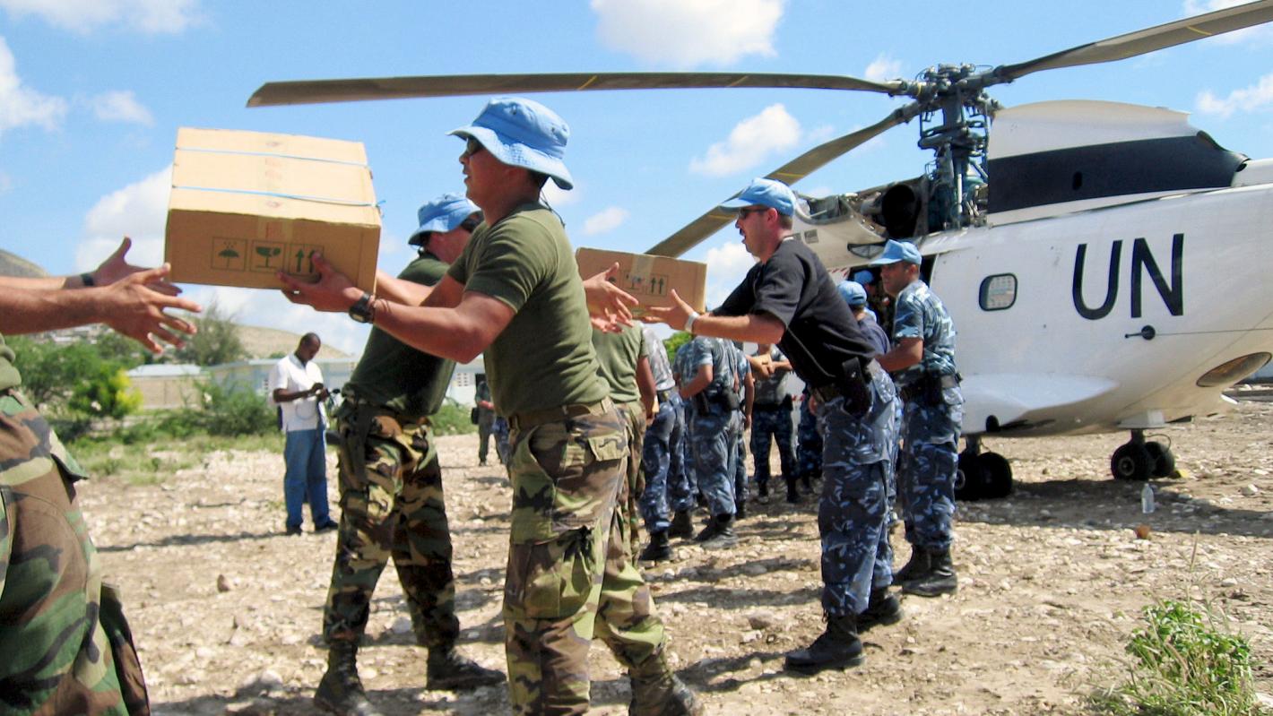 Humanitarian aid is disembarked from a United Nations helicopter.