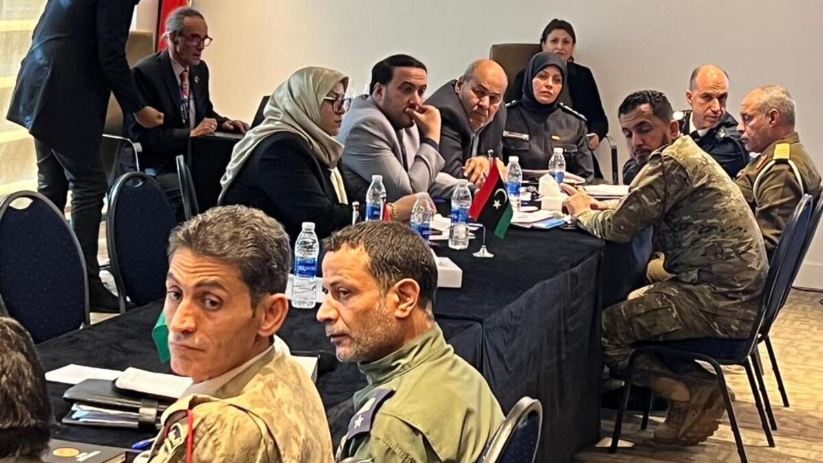 Photo of a group of men and women discussing the implementation plan of the security code of conduct 