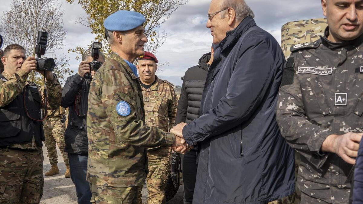 Commander Lieutenant General Aroldo Lázaro shakes hands with Lebanese Prime Minister Najib Miqati.