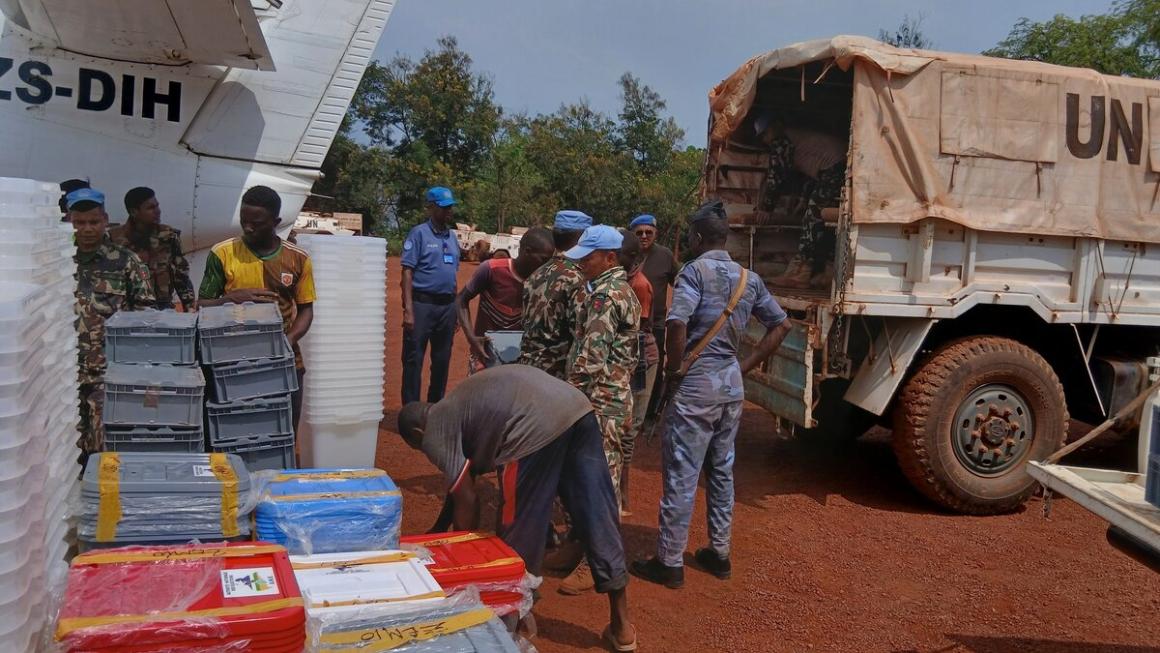MINUSCA peacekeepers unload boxes from a UN truck