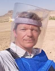 a man's headshot with protective mask